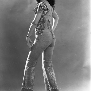 Vintage uk. portrait photo of Woman wearing embroidered flared denim trousers, 1976