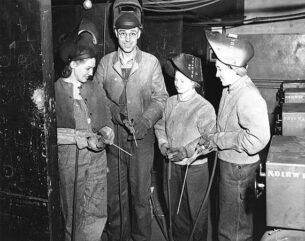 Factory workers wearing denim jumpsuits