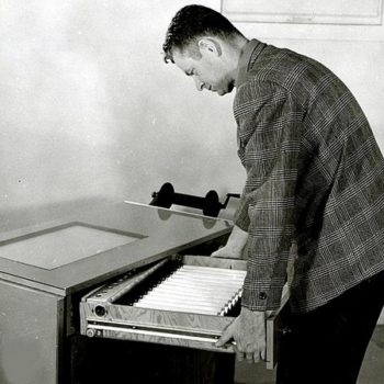 Vintage office wear-John Wear with office light table drawer open, 1958 Portland, Oregon.Photo by Wally C.Guy