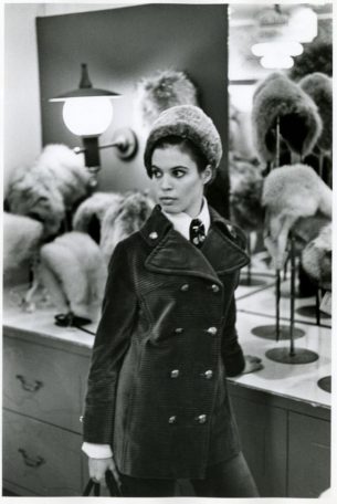 60 70s fashion, Woman standing in front of department store hat display