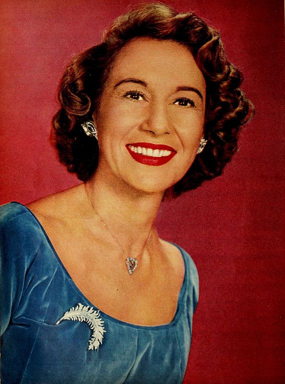 Arlene Francis wears blue velvet dress, silver leaf brooch and heart shaped pendant necklace, - TV Radio Mirror, February 1957